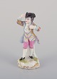 Meissen, Germany, porcelain figurine of a young man in elegant attire. 
Hand-painted in polychrome colors.