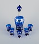 Venice, Italy. A liqueur set in blue glass consisting of a decanter and five 
cups. Hand-painted with silver decoration featuring Venice motifs.