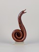Murano, Italy. Large sculpture depicting a cobra snake crafted in art glass. The 
glass features brown and orange tones with a clear glass base.