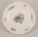 Meissen, Germany. Hand-painted dinner plate featuring a butterfly on a branch 
and polychrome flower motifs. Gold rim.