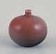 Carl Harry Stålhane (1920-1990) for Rörstrand, Sweden. Vase with a round shape 
and a small neck. Brown-toned glaze.