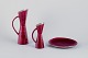Carl Harry Stålhane (1920-1990) for Rörstrand. Two pitchers and a plate in 
ceramic. Burgundy-colored glaze.
