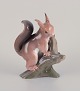 Bing & Grøndahl. Rare porcelain figurine of a squirrel on a tree stump.