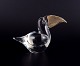 Murano, Italy. Small art glass sculpture of a toucan in clear glass with a 
gold-colored glass beak.