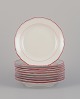 Meissen, Germany. A set of ten plates. Decorated with coral red and gold-colored 
trim. Art Deco.