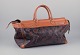 L'Art presents: 
Longchamp, 
France. Travel 
bag in 
full-grain 
leather with a 
rose motif.