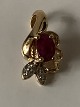 Pendant 14 carat gold, with a red ruby &#8203;&#8203;and embedded diamonds.