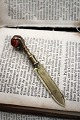 K&Co. presents: 
Antique 
19th century 
brass bookmark 
with an eagle's 
claw gripping a 
marble ball...