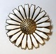 Lundin Antique 
presents: 
Georg 
Jensen. Daisy 
brooch sterling 
silver with 
white enamel 
(925). Diameter 
4,2 cm.