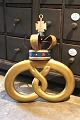 K&Co. presents: Old baker's sign shaped like a pretzel, gilded with a metal crown...