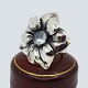 Antik Damgaard-Lauritsen presents: Regitze Overgaard for Georg Jensen; Flowerring in silver with moonstone, no. ...
