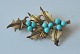 Pegasus – Kunst - Antik - Design presents: Gilded silver brooch with turquoises, 20th century.