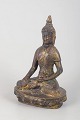 L'Art presents: Gilt bronze Buddha figure.