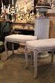 K&Co. presents: Old rococo stool in wood with a fine gray patinated color and seat upholstered in linen...