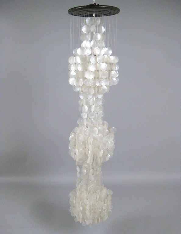 Seashell pendant lamp with mother of pearl flakes.