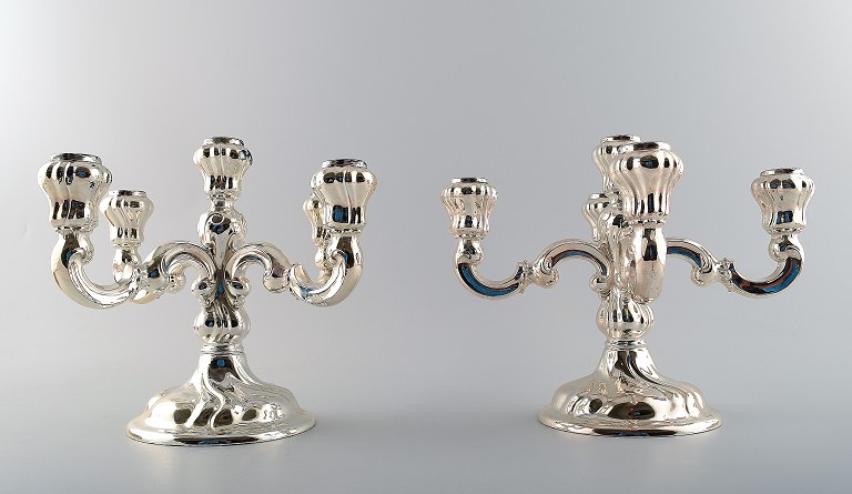 Par American five-armed silver candlesticks.
