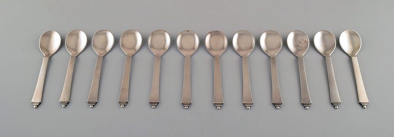 Set of twelve Georg Jensen sterling silver pyramid sorbet spoons in all sterling 
silver.