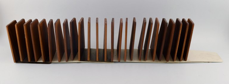 Danish design: 25 stylish bookstands in teak and stainless steel. 1960 s.
