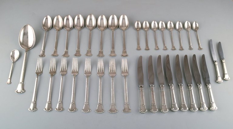 S. Chr. Fogh, 1912-1973. Danish silversmith. "Beaded" cutlery in hammered 
silver. Complete lunch service for eight people. 1930-60