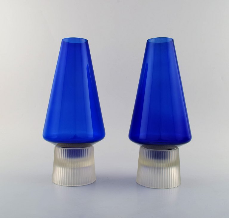 Per Lütken for Holmegaard. A pair of rare "Hygge" lamps for candles in blue and 
clear art glass. Designed in 1958.