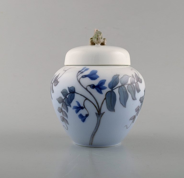 Royal Copenhagen. Porcelain lidded jar with grasshopper and flowers. Ca. 1920.
