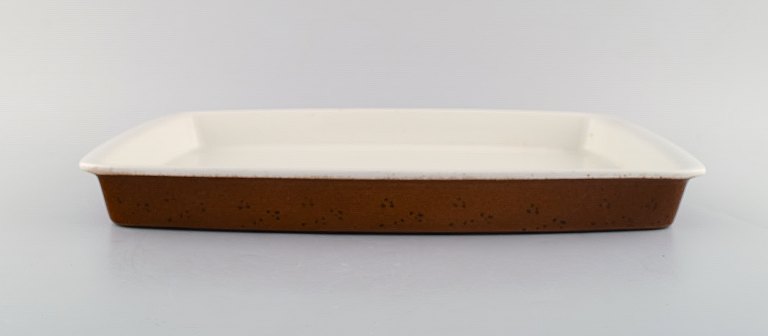 Stig Lindberg for Gustavsberg. Large "Coq" ovenproof tray in glazed stoneware. 
Rustic design, 1960