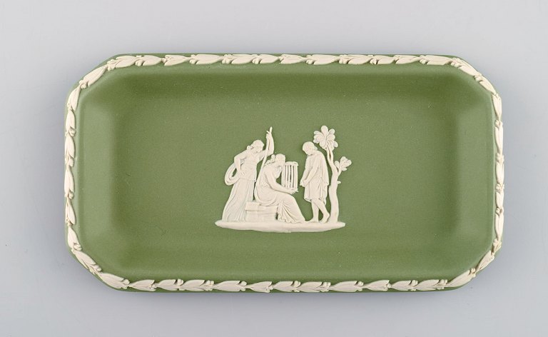 Wedgwood, England. Small square dish in green stoneware with classicist scenes 
in white. Approx. 1930.
