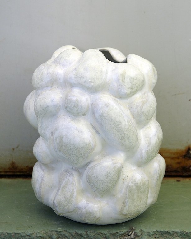 Christina Muff, Danish contemporary ceramist (b. 1971).Medium sized white 
stoneware sculpture vase with porcelain slip. The vase is hand modeled and has 
been glazed with white glaze as a base, the bulges are decorated with soft green 
crystal glaze.