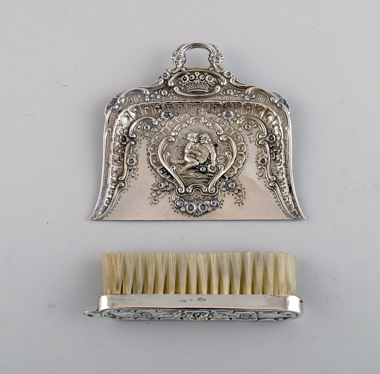 Antique table sweeping set in silver (835) with erotic motif. Approx. 1900.
