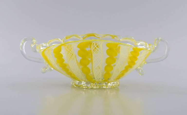 Murano bowl with handles in mouth-blown art glass. Wavy and checkered design in 
shades of yellow and white. 1960s.
