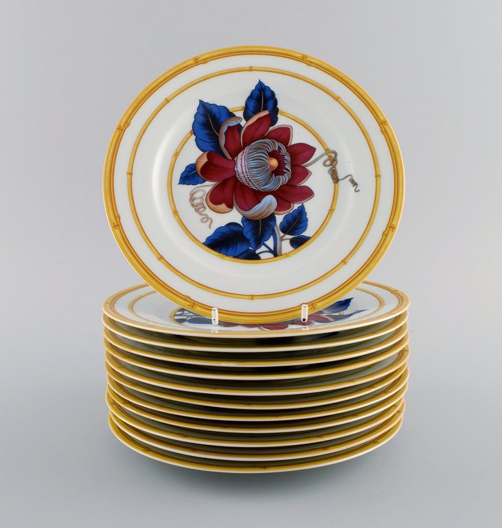 Porcelain of Paris. "Tropical Aurore". 12 porcelain lunch plates decorated with 
flowers and bamboo. 1980s.
