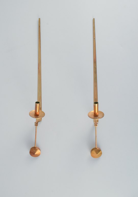 Skultuna, Sweden, four brass candlesticks for wall hanging.
Designed by Pierre Forsell.