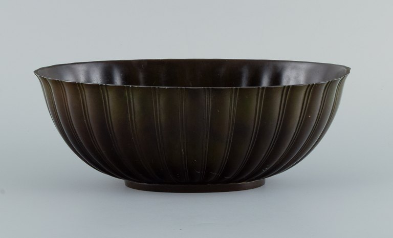 Just Andersen. Jardiniere of patinated disco metal with grooved body.