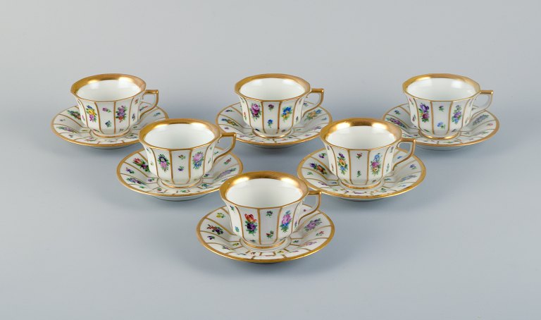 Royal Copenhagen, six Henriette mocha cups and saucers hand-painted with flowers 
and gold decoration.