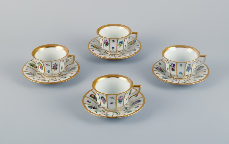 Royal Copenhagen, four Henriette mocha cups with saucers hand-painted with 
flowers and gold decoration.