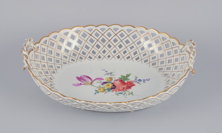 Meissen, Germany. Colossal open lace oval bowl. Hand-painted with polychrome 
flower motifs and gold trim.