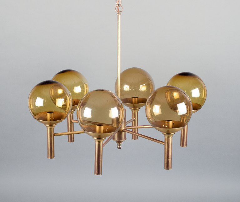 Sv. Mejlstrøm, Danish designer. Brass chandelier with six arms and dome-shaped shades made of amber-colored glass.