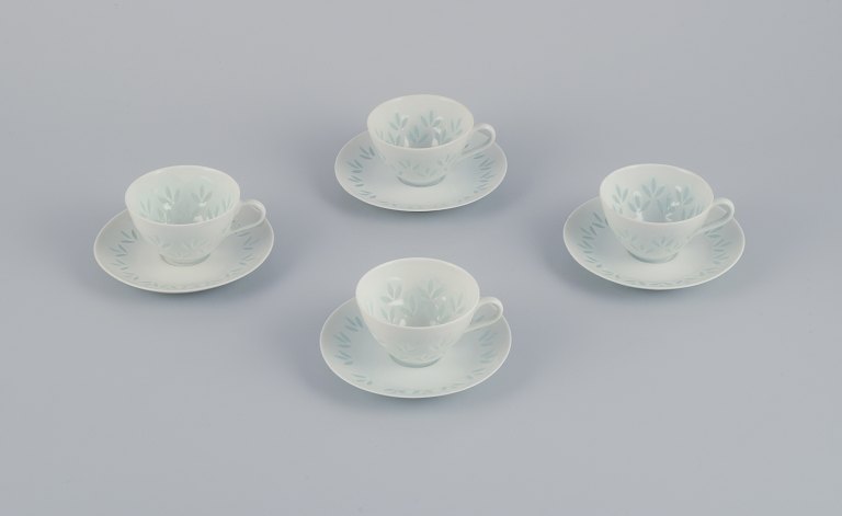 Friedl Kjellberg for Arabia, Finland. A set of four coffee cups with matching 
saucers in rice porcelain.