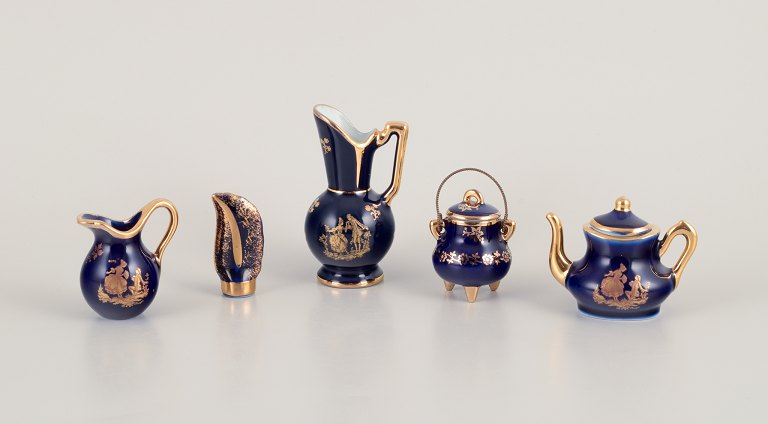 Limoges, France. Five pieces of miniature porcelain decorated with 22-karat gold 
leaf and beautiful royal blue glaze.