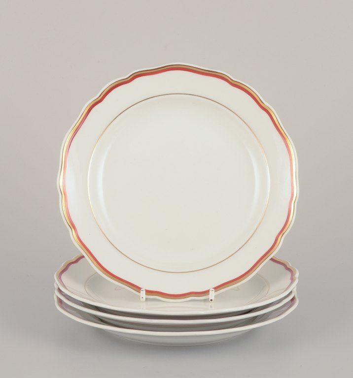 Meissen, Germany. A set of four plates. Decorated with coral red and 
gold-colored trim. Art Deco.