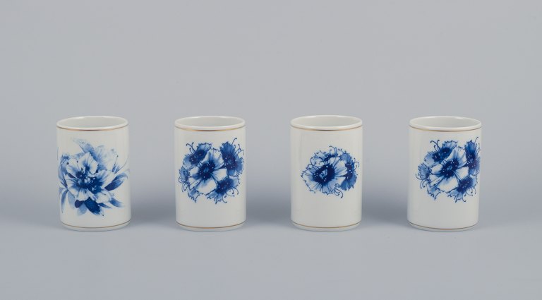 Meissen, Germany. Four vases. Hand-decorated with blue floral motifs, gold rim.