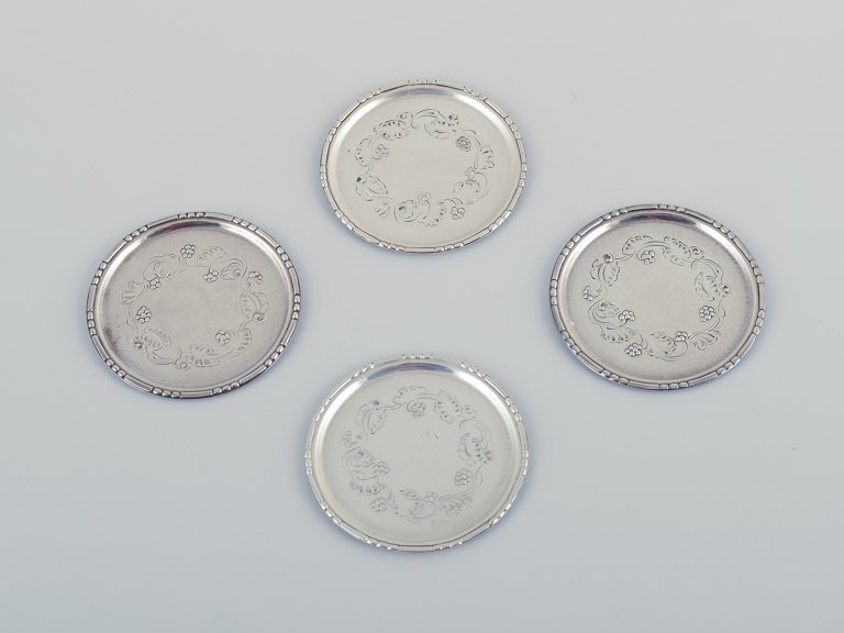 Georg Jensen, a set of four glass coasters in sterling silver.