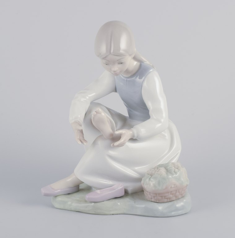 NAO, Spain.
Porcelain figurine of a girl having a rest.